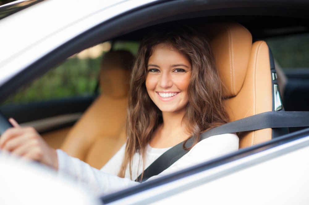 Smiling woman driving. Why choose AAA insurance image